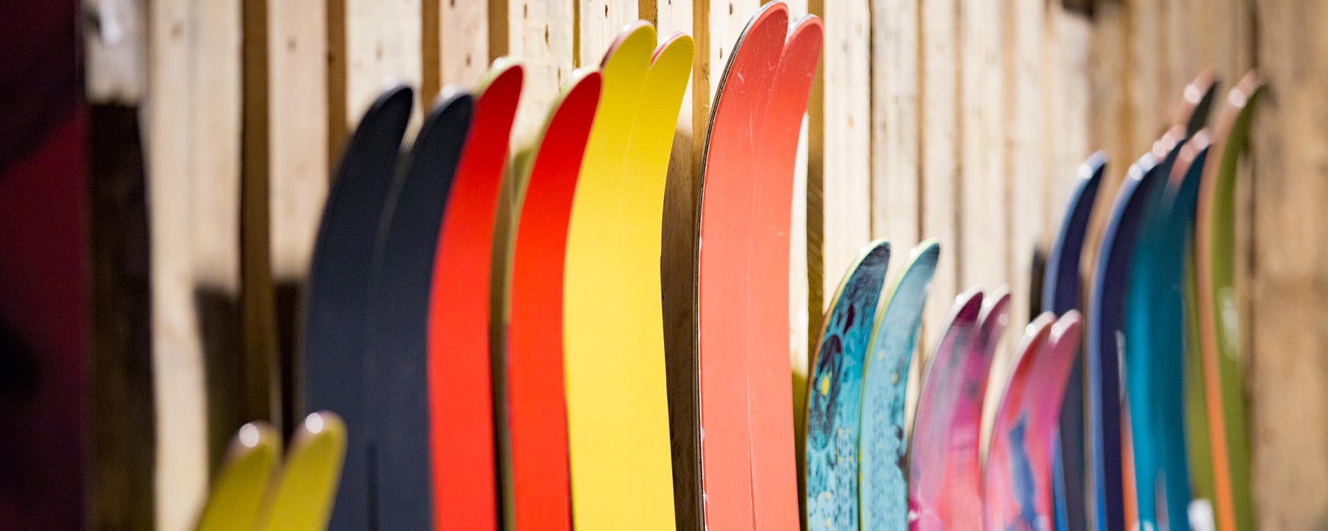 close up of some colored skies standing in a ski rental